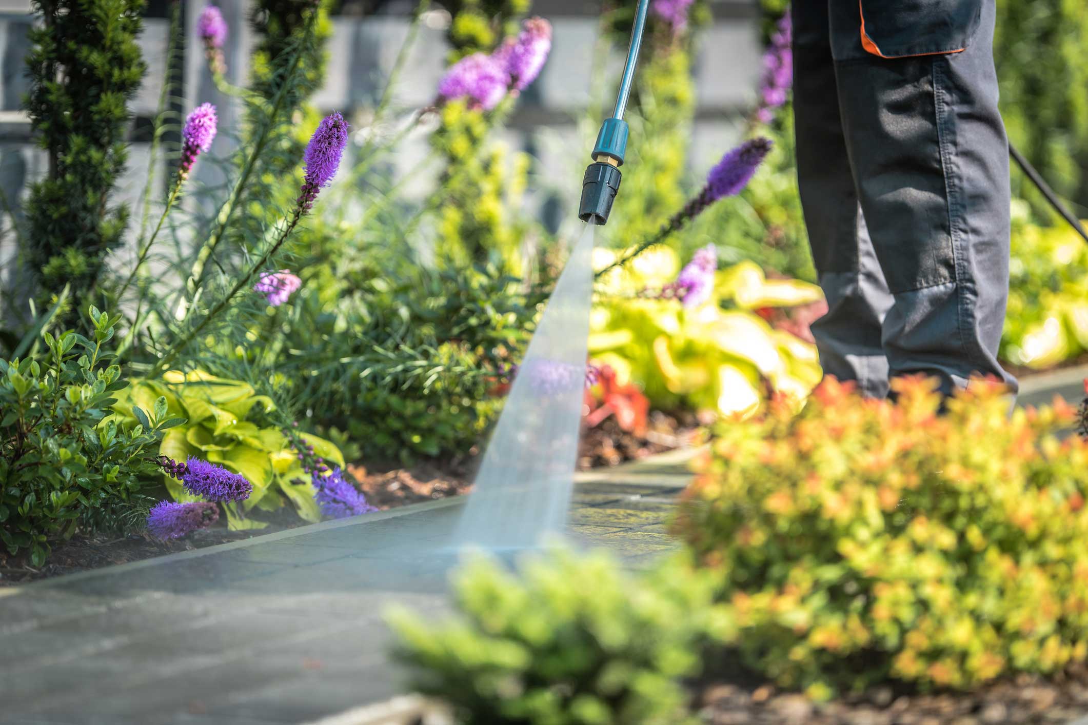 Power Washing Garden Paths. Power Washing Garden Cobble Stone Paths. Outdoor Cleaning Using Pressure Washer. Closeup Photo.